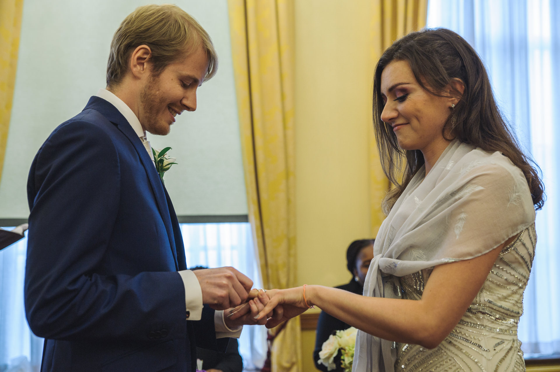 islington town hall wedding groom and bride exchanges the rings